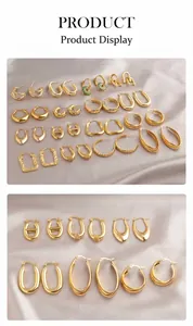 Collection of geometric gold earrings in hoop, teardrop, and square shapes on silk