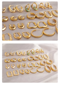 Collection of geometric gold plated hoop earrings with diverse textures on silk fabric