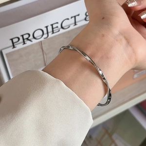Minimalist silver Mobius twist cuff bracelet in polished titanium steel for women
