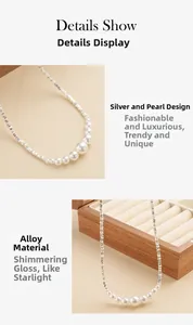 Detailopname van de ketting met onregelmatige zilveren kralen en witte parels