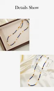 Detailed macro view of beaded necklace with blue natural stone pearls and gold clasp