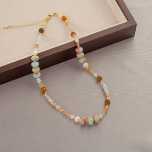 Natural stone and freshwater pearl beaded necklace with gold accents and bohemian style