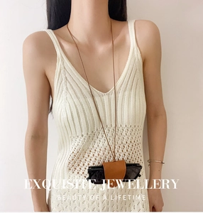 Brown leather glasses holder necklace pouch styled on white crochet dress