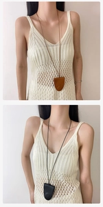 Detail of minimalist leather pendant necklaces with fine stitching in brown and black