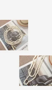 Detailed close-up of double-layer layered pearl necklace with elegant round pearls