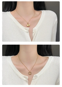 Detailed shot of gold-plated Fu character and handbag pendant necklaces on model