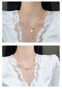 Detail view of retro gold Fu character pendant and bamboo style bar necklace for women