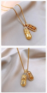 Detailed close-up of golden Pixiu pendant with white rhinestones and braided chain link