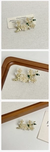 Detail of floral brooch with gold plating, pearls and sparkling diamond accents