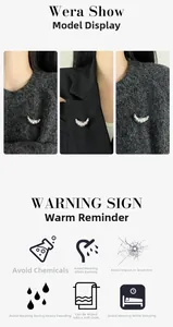 Detail view of silver croissant brooch with pleated texture on grey sweater and black blazer