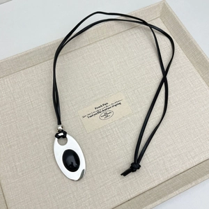 Minimalist long necklace with silver oval black gemstone pendant and black leather cord