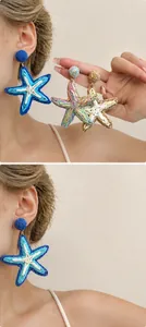 Macro detail of oversized woven raffia starfish earrings in bohemian beach holiday style