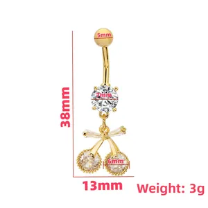 Golden cherry belly button ring with zircon bow drop on a minimalist white background