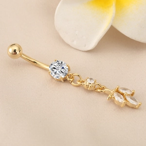 Detail view of gold belly button ring with large round and marquise zircon leaf pendant