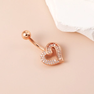 Rose gold heart belly button ring with sparkling zircon stones on a pink background