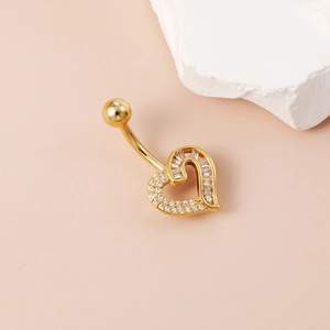 Detailed view of golden heart navel ring with baguette and round cubic zirconia stones