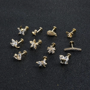 Golden flower butterfly zircon labret stud set for cartilage piercing on black background