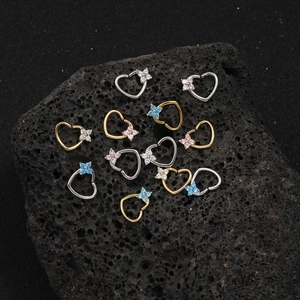 Exquisite heart-shaped piercing ring with zircon flower on dark volcanic rock