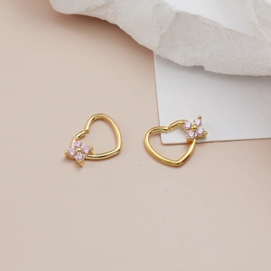 Golden heart-shaped nose ring with micro-set pink zircon flower on textured stone
