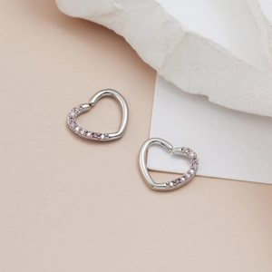 Detail of silver heart hoop earrings with micro-set pink cubic zirconia gemstones