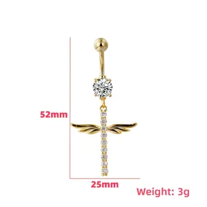 Macro shot of gold cross and angel wings navel ring with crystal size specs 52mm by 25mm