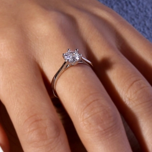 Classic six-prong solitaire ring with a brilliant round diamond on a silver adjustable band