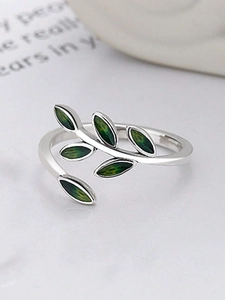 Close-up of silver leaf ring featuring green enamel leaves and adjustable branch band