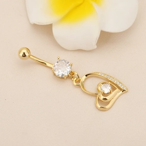 Macro detail of gold-plated navel ring with hollow heart pendant and zircon stones