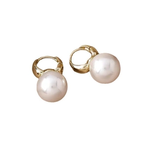 Detail of round faux freshwater pearl earrings with elegant gold plated hoop design