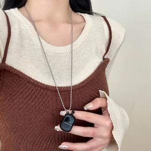 Minimalist long beaded necklace featuring a creative black perfume bottle pendant charm