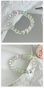 Detail of colorful crystal bead bracelet with silver spiral beads on elegant white background