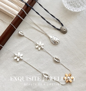 Exquisites Halsketten-Set mit blauem Muschelanhänger und Perlenblumen-Details