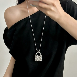 Silver beaded bag pendant long necklace on model with minimalist beaded ball chain