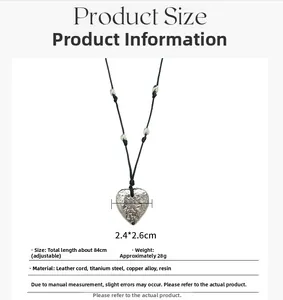 Detail of silver heart pendant with textured finish on adjustable black leather cord