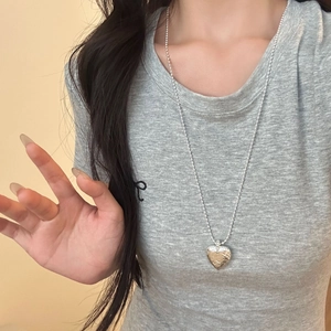 Adjustable silver heart necklace with hammered texture and long bead chain for women