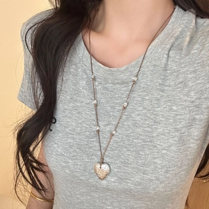 Minimalist adjustable heart pendant necklace with textured silver heart and brown cord