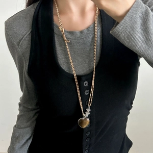 Collana con ciondolo a cuore in pietra occhio di tigre con cordino su maglia grigia