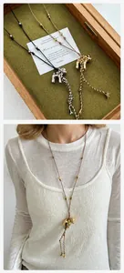 Detail view of a puppy pendant necklace with adjustable cord and tassel design