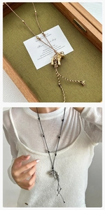 Detail of minimalist puppy tassel pendant on a premium woven rope necklace