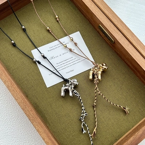 Puppet tassel pendant necklace in gold and silver finish with braided rope chain