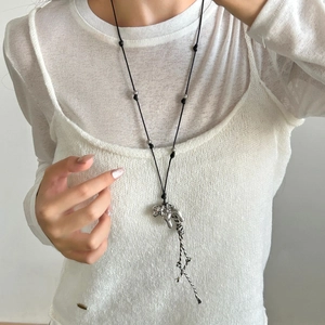 Minimalist long puppy tassel necklace with irregular fluid silver pendant on black rope