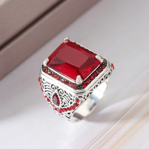 Vintage men's ring with large rectangular red zircon and intricate silver-toned carvings