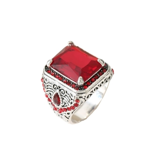 Vintage silver ring with emerald-cut red stone and intricate filigree details