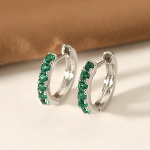 Silver-colored hoop earrings set with five round green cubic zirconia in claw settings