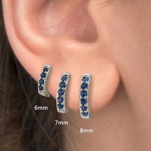 Silver huggie earrings with blue zircons available in 6mm, 7mm, and 8mm sizes