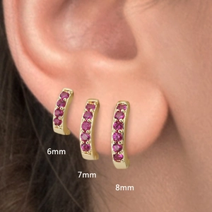 Close-up of 6mm 7mm 8mm gold huggie earrings with pave pink zircon for multiple piercings