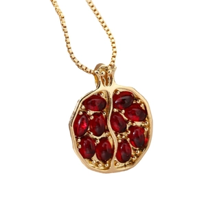 Elegant pomegranate pendant necklace with red crystals on a gold box chain for women