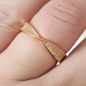 18k gold plated twist band ring featuring pave cubic zirconia and crisscross design