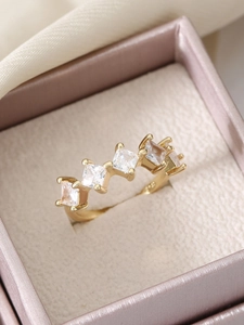 Detailed macro view of gold-plated S925 silver ring with four square zirconia stones