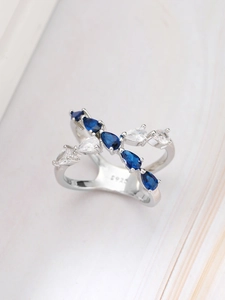 Macro shot of S925 hallmark on polished silver ring with blue and white teardrop gems